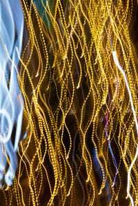 Low angle view of illuminated christmas lights against sky at night