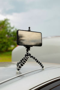 Close-up of telephone pole against sky