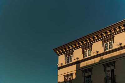 Low angle view of building against clear blue sky