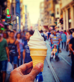 Close-up of hand holding ice cream cone