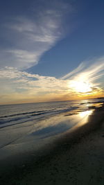 Scenic view of beach against sky during sunset