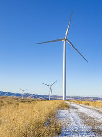 Wind turbines in a field with blue sky