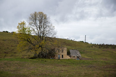 Built structure on field against sky