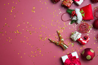 Directly above shot of christmas decorations on red background