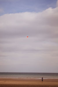 Boy flying kite at beach