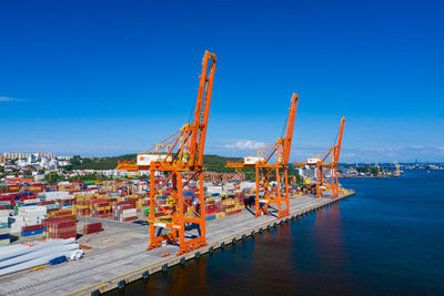 Commercial dock by sea against sky