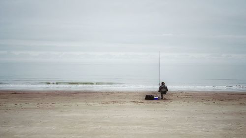 People on beach against sky