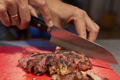 Close-up of person preparing food on cutting board