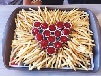 High angle view of french fries with ketchup in tray on table