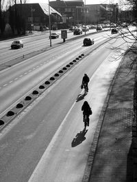 High angle view of man walking on tire tracks