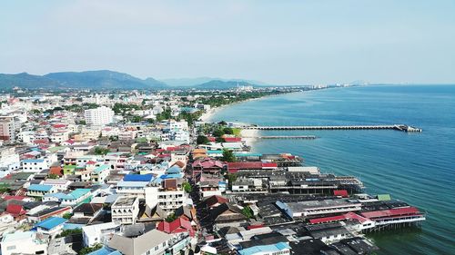 High angle view of city by sea against sky