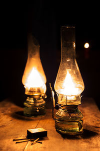 Close-up of illuminated light bulb on table