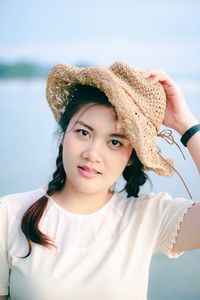 Portrait of beautiful young woman wearing hat