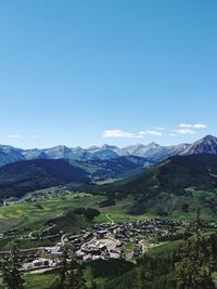 Scenic view of mountains against blue sky