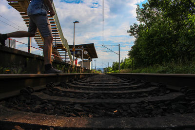 Railroad track against cloudy sky