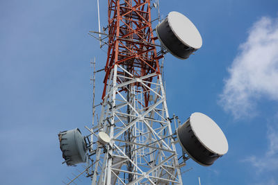 Low angle view of communications tower against sky