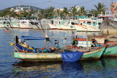 Boats moored at harbor in sea