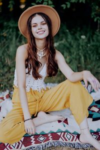 Portrait of young woman wearing hat