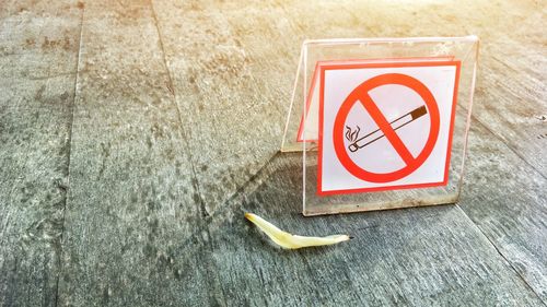 Close-up of no smoking sign on road