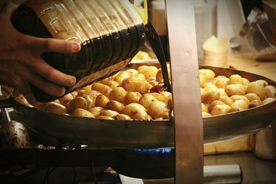 Close-up of man preparing food at market stall