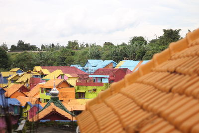 High angle view of houses and trees against sky