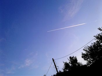 Low angle view of vapor trails in sky