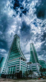 Low angle view of buildings against cloudy sky