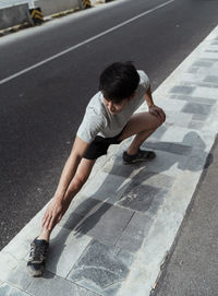 High angle view of young man on road