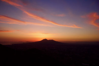 Scenic view of silhouette mountains against sky during sunset