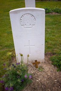 Close-up of cross on grass in field