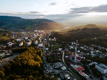 High angle panorama view of townscape against sky with trees and hils and buildings