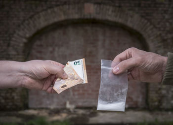 Close-up of hand holding paper