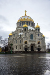 View of lake by cathedral against sky