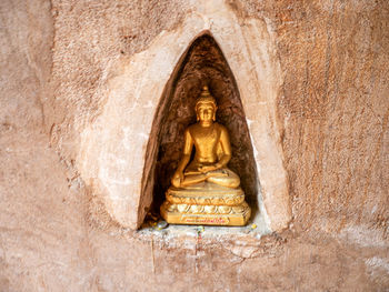 Statue of buddha on wall