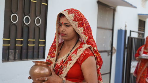 Indian woman holding mangal kalash in hand. kalash is considered as symbol of life in hindu religion