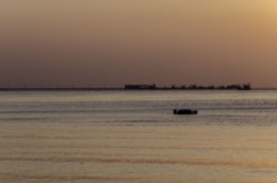 Scenic view of sea against clear sky during sunset