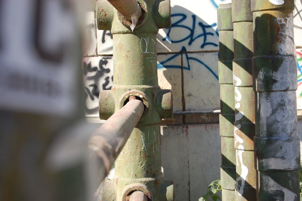 CLOSE-UP OF METAL FENCE AGAINST PLANTS