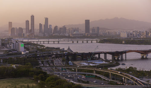 High angle view of bridge over river by buildings in city