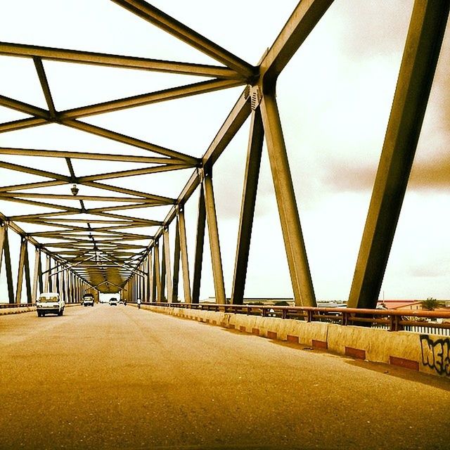 transportation, connection, the way forward, bridge - man made structure, diminishing perspective, sky, built structure, engineering, architecture, vanishing point, metal, road, railing, bridge, low angle view, metallic, long, clear sky, day, outdoors