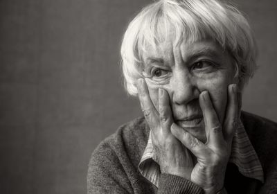 Close-up of senior woman with hands on chin