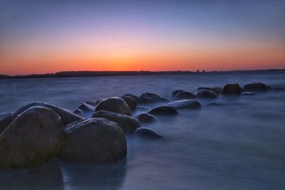 Scenic view of calm sea at sunset