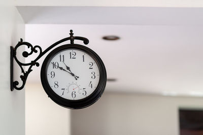 Close-up of clock on wall at home