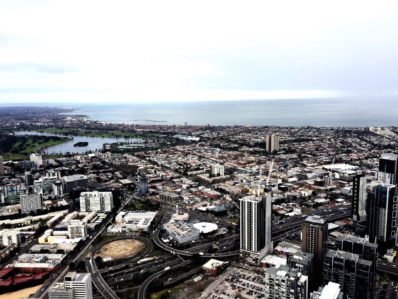 HIGH ANGLE VIEW OF CITY AGAINST CLOUDY SKY