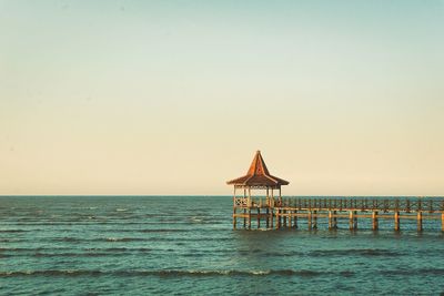 Lifeguard hut on beach against clear sky