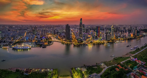 Aerial view of buildings in city during sunset