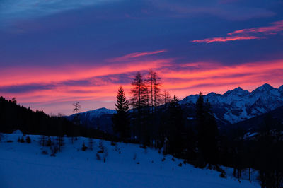 Scenic view of snow covered landscape against sky during sunrise