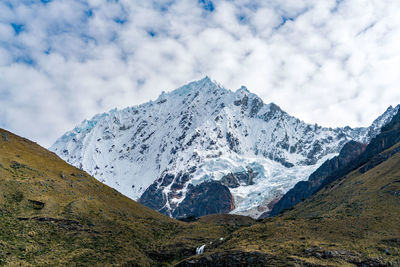 Low angle view of snowcapped mountains against sky