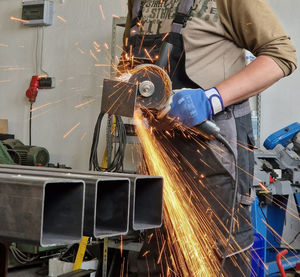 Midsection of man working in factory