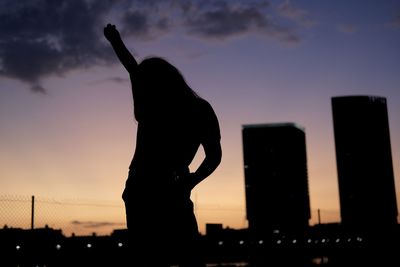 Silhouette man standing against sky during sunset