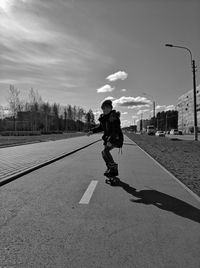 Rear view of man walking on street in city